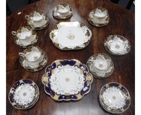 A ROCKINGHAM TYPE PART TEA SERVICE with blue, cream and gilt decoration, marked 'Rockingham Reproduction, by Tate & Oglesby'