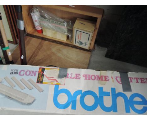 A vintage brother knitting machine and accessories