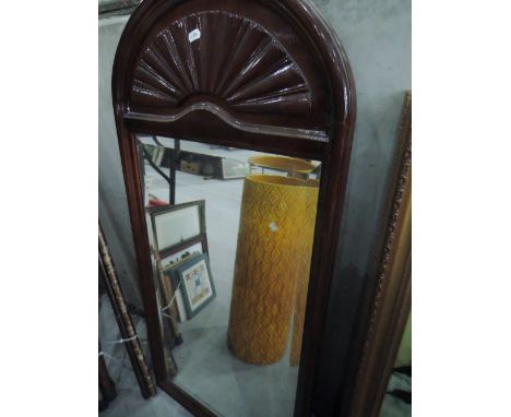A vintage mahogany fan top wall mirror