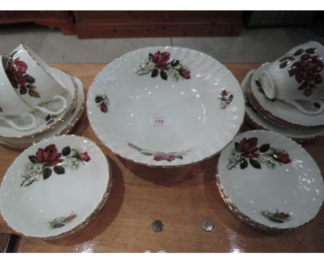 A part tea service in white and gilt with rose decoration