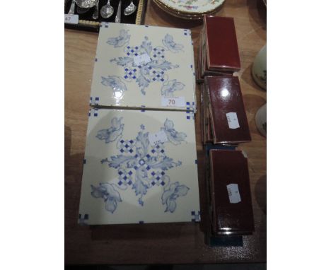 Ten blue and white decorative ceramic tiles  and 14 edging tiles