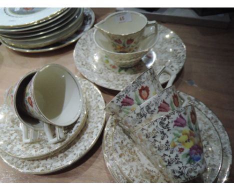 A mid 20th century part tea service with floral and gilt decoration (20 pieces approx)