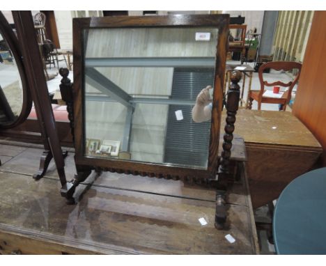 An early 20th Century dressing mirror having bobbin turned frame