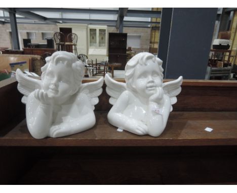 A pair of late 20th Century ceramic cherub ornaments