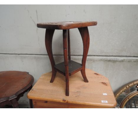 A vintage poker work plant stand
