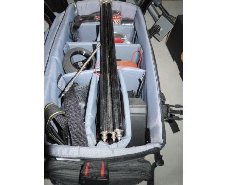 A bag of camera accessories including filters, light meters, tripods etc