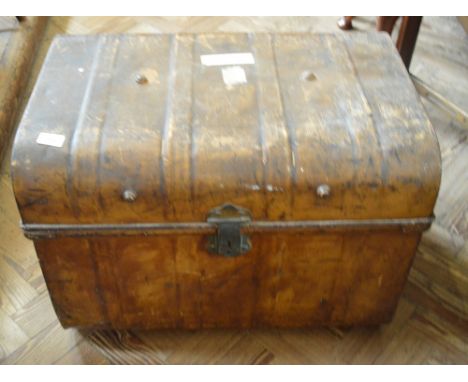 A metal trunk and a table on castors