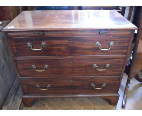 A Georgian Mahogany chest of three long drawers on bracket feet with brush slide