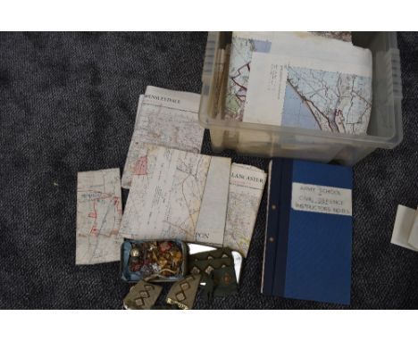 A box containing MOD Ordnance Survey Maps, Army School of Civil Defence Instructor Notes Training Manual, a tin of Border Reg