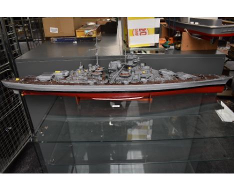 A hand built wooden and plastic scale model of Bismarck, on wood stand, with building instructions, a good example
DIMENSIONS