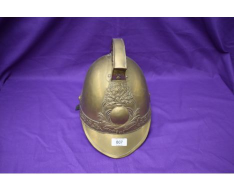 A vintage French brass Firemans Helmet, Pompiers De Amponville, with leather chin strap and lining