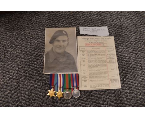 A group of four WW2 miniature medals, 39-45 Star, France Germany Star, War Medal and Defence Medal with photo