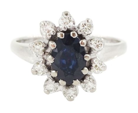 White gold oval cut sapphire and round brilliant cut diamond cluster ring, stamped 18ct, total diamond weight approx 0.40 car