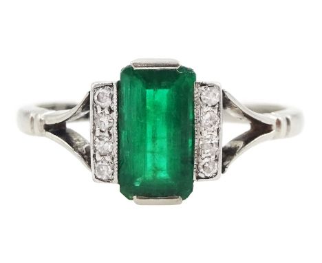 Early 20th century platinum emerald cut emerald and eight stone single cut diamond ring, stamped PT, emerald approx 0.70 cara