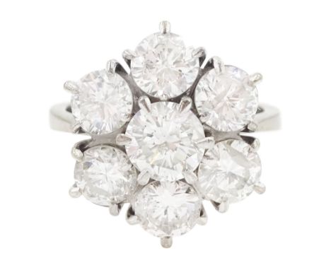 18ct white gold seven stone round brilliant cut diamond flower head cluster ring, London 1977, principal diamond approx 0.75,