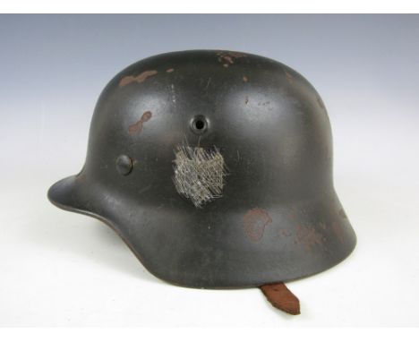 A Second World War German Model 1940 steel helmet, shell stamped ET62, single Army decal removed 