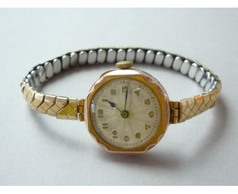A 1930s lady's 9ct gold cased wristlet watch, with Swiss made manual wind movement, circular faceted case engraved verso with
