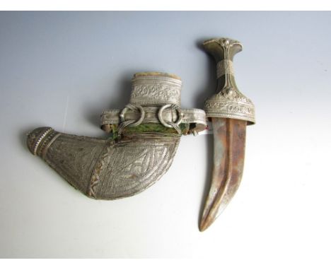 A North African jambiya, having white-metal-mounted horn hilt and conforming scabbard, first half 20th Century, 31 cm long in