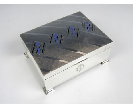 A George V silver table cigarette box, of rectangular section, with a subtly domed hinged cover bearing diagonal engine-turne