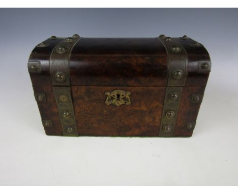 A Victorian burr walnut veneered tea caddy, of rectangular section with a domed cover, decorated with engraved brass strapwor