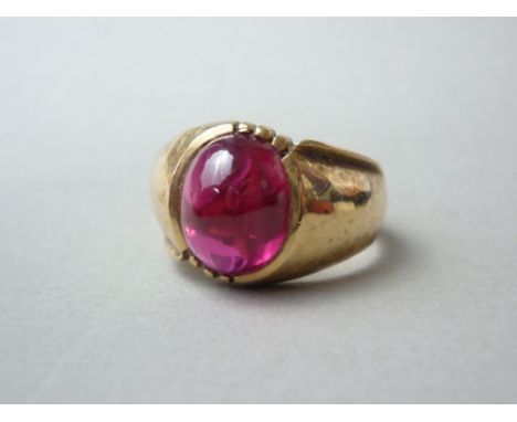 A 10K gold ring set with a 6ct synthetic ruby cabochon