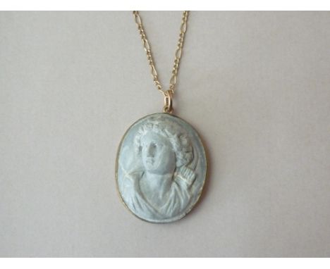 A 19th Century lava cameo pendant necklace, bass carved with the portrait of a Classical goddess, collet set and suspended on