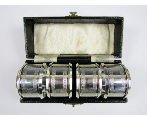 A cased set of Edward VIII silver napkin rings, each with engine turned decoration, Birmingham, 1936, 61.8g 
