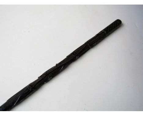 An Irish bog oak walking stick, relief-carved in a pattern of shamrock with a cross and tower, 87 cm 