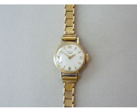 A 1960s lady's 9ct gold cased Longines wrist watch, having manual wind movement, circular dial with silvered face, Arabic num