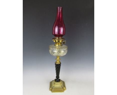 A late Victorian brass oil lamp, with Hinks patent No.2 lever duplex burner, spirally fluted and tapering ebonised column, an