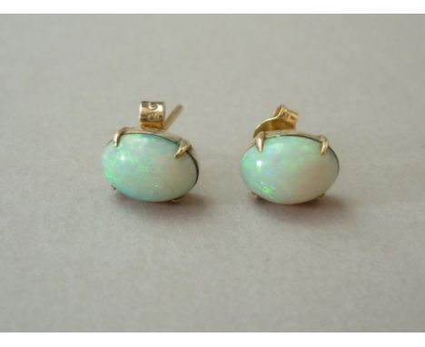 A pair of opal stud earrings, each having a crown set cabochon stone of approximately .78ct, on 9ct gold 