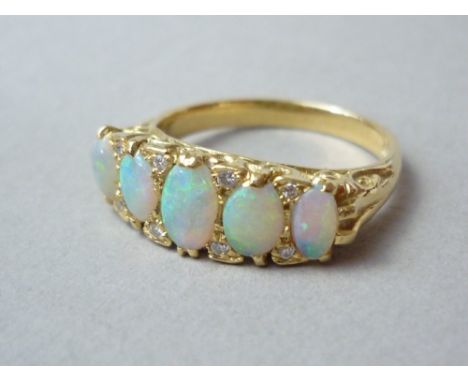 A diamond and opal dress ring, with five graded oval cabochons, the largest of which being approximately .28ct, interspersed 