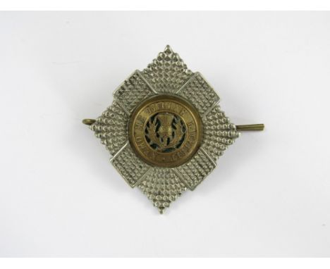 A Royal Scots officer's bi-metallic and enamel cap badge 