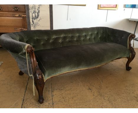 A Victorian sofa, having a Chesterfield type low button-upholstered back, serpentine front and carved legs, 185 cm x 56 cm 