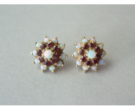 A pair of opal and garnet flower-head cluster stud earrings, the stones claw set on 9ct gold 