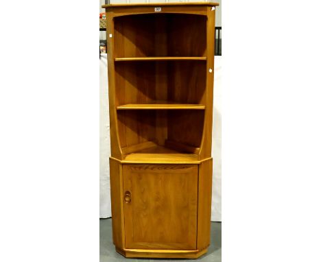 An Ercol elm corner cabinet with two open shelves above a cupboard  base, W: 76 cm, H: 180 cm. Not available for in-house P&a