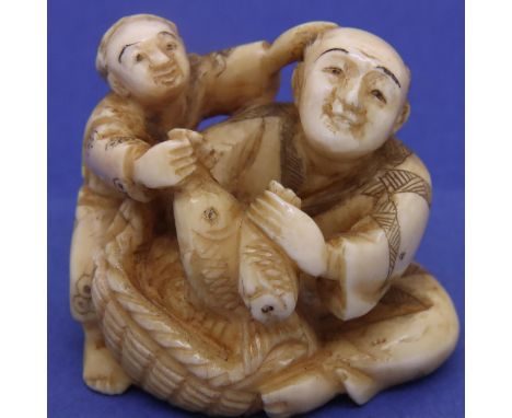 Ivory carved netsuke in the form of a seated fish vendor with a boy, H: 35 mm, signed to base. P&amp;P Group 1 (£14+VAT for t