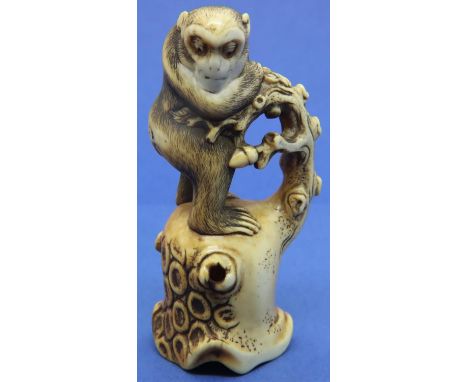 Ivory carved netsuke in the form of a monkey standing on a tree, H: 56 mm, unsigned. P&amp;P Group 1 (£14+VAT for the first l