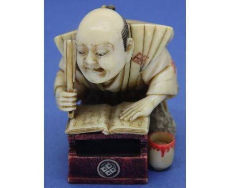 Ivory carved netsuke in the form of a scribe with polychrome decoration, H: 46 mm, signed to panel on base. P&amp;P Group 1 (