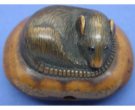 Boxwood carved netsuke in the form of a rat with stone set eyes on a cushion, L: 48 mm, unsigned. P&amp;P Group 1 (£14+VAT fo