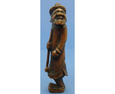 Carved boxwood netsuke in the form of a standing bearded man holding a staff, H: 57 mm, unsigned. Good condition, no visible 