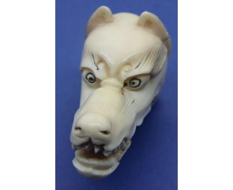 Ivory carved netsuke in the form of a wolf head, L: 45 mm, unsigned. P&amp;P Group 1 (£14+VAT for the first lot and £1+VAT fo