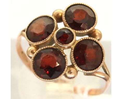 An Edwardian 9ct gold dress ring set with five garnets, size K, 1.6g. Shank misshapen. P&amp;P Group 1 (£14+VAT for the first