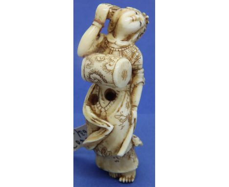 Ivory carved netsuke in the form of a reclining woman, L: 68 mm, signed to base. Overall good condition. P&amp;P Group 1 (£14