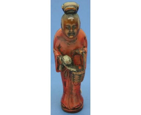 Boxwood carved netsuke seal in the form of a figure carrying a basket and a fruit, H: 75 mm, unsigned. Slight wear to holes, 