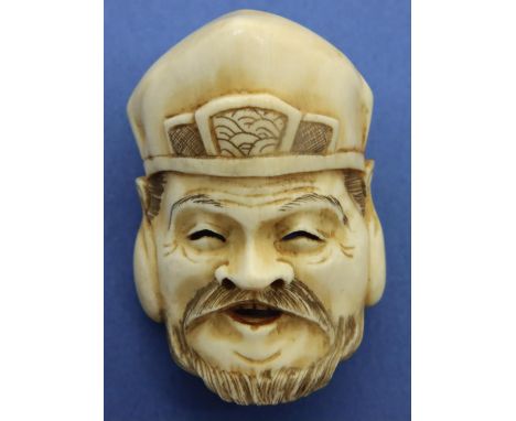 Ivory carved netsuke in the form of a mask, H: 45 mm, signed to verso. P&amp;P Group 1 (£14+VAT for the first lot and £1+VAT 
