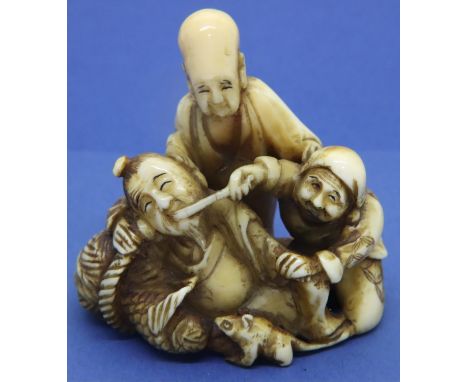 Ivory carved netsuke in the form of three figures with a rat and a fish, H: 54 mm, unsigned. P&amp;P Group 1 (£14+VAT for the