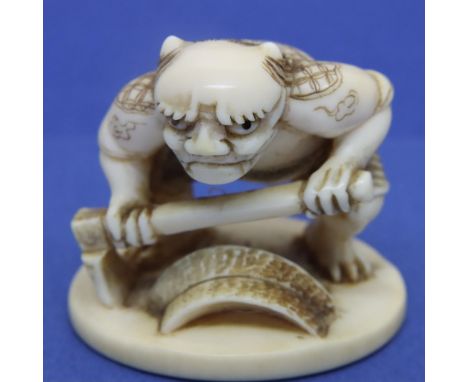 Ivory carved netsuke in the form of a figure with an axe, H: 33 mm, signed to a panel in the base. P&amp;P Group 1 (£14+VAT f