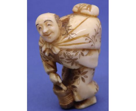 Ivory carved netsuke in the form of a man carrying a sack and holding a bucket, H: 44 mm, signed to base. P&amp;P Group 1 (£1