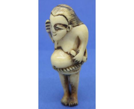 Ivory carved netsuke in the form of a naked pregnant woman with a rope belt, H: 57 mm, unsigned. Some wear to holes, age spli